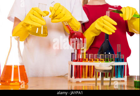 school children doing chemistry science experiment