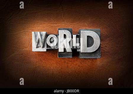 The word world made from vintage lead letterpress type on a leather background. Stock Photo