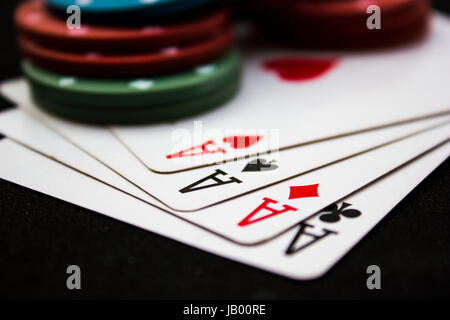 Cards laying around with poker chips on top. Stock Photo