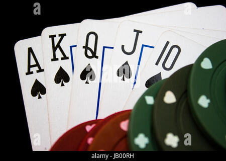 Cards laying around with poker chips on top. Stock Photo