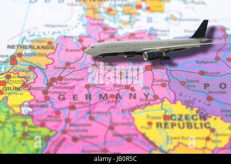 Berlin in Germany pinned flight of plane travel on colorful political map of Europe. Geopolitical school atlas. Holidays and travel concept. Flights t Stock Photo