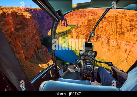 Helicopter cockpit with pilot arm and control console inside the cabin on the Grand Canyon Lake Powell. Reserve on the Colorado River, straddling the  Stock Photo