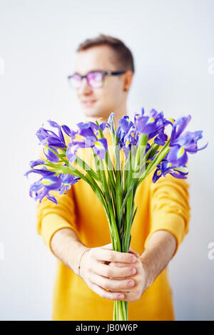 Young Man with Beautiful Spring Flowers Stock Photo