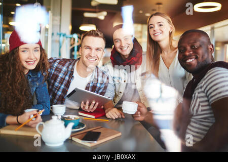Enthusiastic Managers Working from Coffeehouse Stock Photo