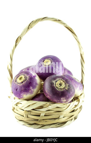 purple headed turnips in straw basket on white background, (clipping work path included). Stock Photo