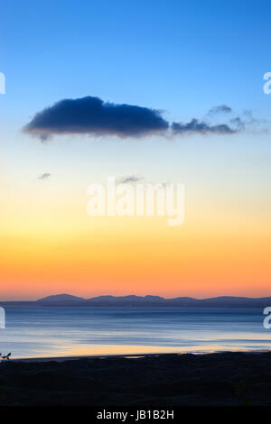 Looking over the Llyn Peninsula and Isle of Anglesey Gwynedd Wales at sunset Stock Photo