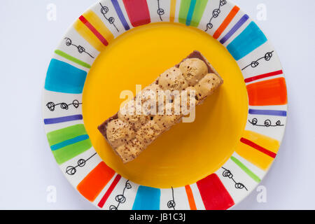 M&S Banoffee cheesecake slice on colourful plate Stock Photo