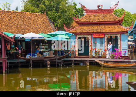 Laem Chabang, Thailand -- March 16, 2016 -- Tourists shopping in a water market in Thailand. Editorial Use Only. Stock Photo