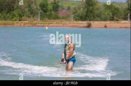 Man study wakeboarding on a blue lake summer sports Stock Photo
