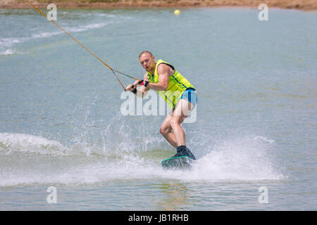 Man study wakeboarding on a blue lake summer sports Stock Photo