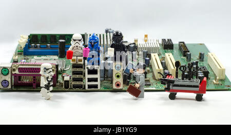 Lego minifigure relaxing on motherboard Stock Photo