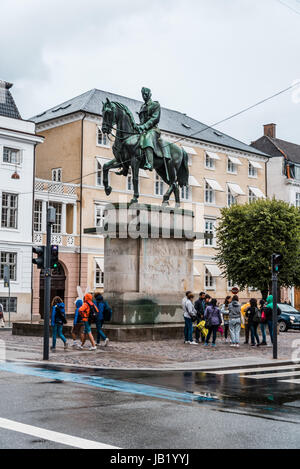 Copenhagen, Denmark - August 10, 2016. Christian X monument with a crowd of tourists a rainy summer day in historical city centre of Copenhagen. Stock Photo