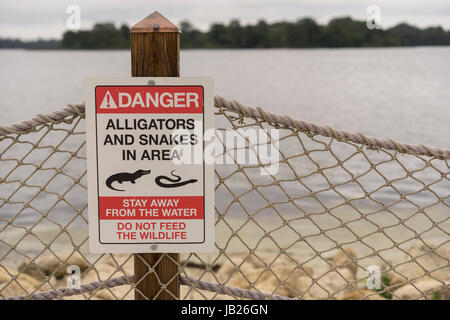 Danger Alligators And Snakes In Area Sign On A Beach Stock Photo