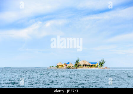 Placencia, Belize - August 28, 2016: Houses & palapas on tiny, tropical island near Placencia in Belize, Central America Stock Photo