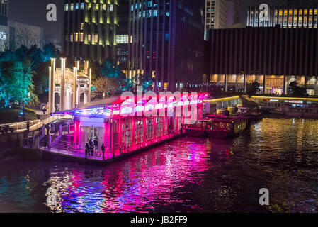 Illuminated Grand Canal pier and commercial skyscrapers beyond it, Hangzhou, Zhejiang province,  China Stock Photo