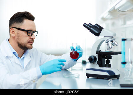 Serious Scientist Performing Medical Research in Lab Stock Photo