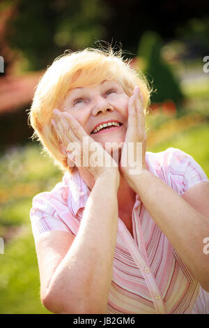 Elation. Ecstasy. Surprised Glad Grey-Haired Senior Woman Looking Up Stock Photo