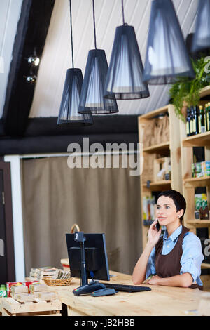 Middle-aged Shop Owner with Smartphone Stock Photo