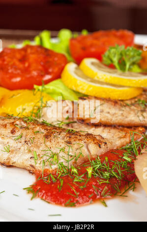 Tasty fish pike perch fillet with vegetables and sauce Stock Photo