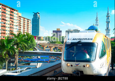 KUALA LUMPUR - MAY 13, 2013: Monorail train arrives at a train station in Kuala Lumpur, Malaysia. Kuala Lumpur metro consists of 6 metro lines operated by 4 operators. Stock Photo