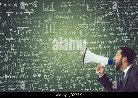 Businessman shouting through megaphone against green chalkboard with mathematical formula Stock Photo