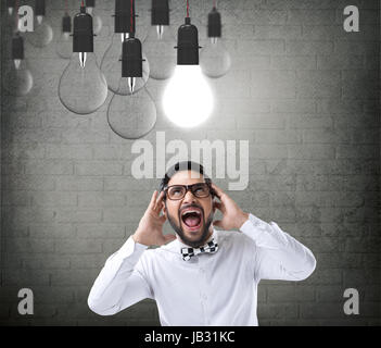 Excited businessman with glowing light bulb Stock Photo