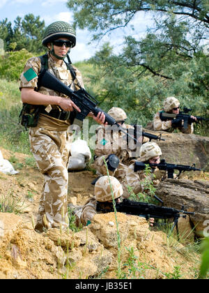 British soldiers in desert uniform in action Stock Photo