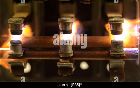Electric relay with sparks jumping between the contacts, due to breaking a heavy inductive load. Stock Photo