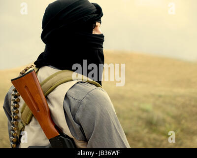 Muslim militant with rifle Stock Photo