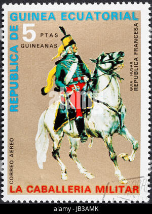 REPUBLIC OF EQUATORIAL GUINEA Guinea - CIRCA 1976: A postage stamp printed in the Equatorial Guinea shows army uniform of military cavalry - hussar officer of French Republic, circa 1976 Stock Photo