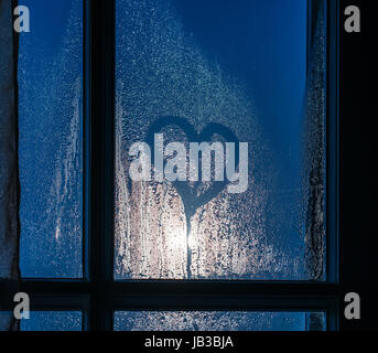 Moonlight through the window. Sweaty glass and heart shape Stock Photo