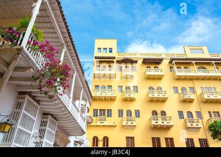 Yellow colonial building next to a white colonial balcony in the historic center of Cartagena, Colombia Stock Photo