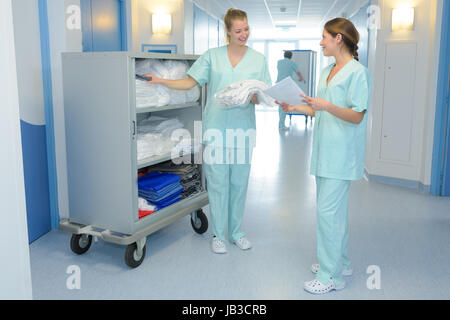 two medical professionals talking in the hallway Stock Photo
