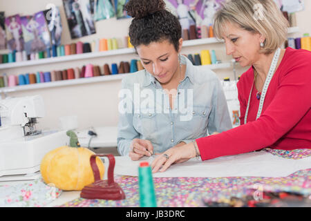 student with teacher in dressmaking class Stock Photo