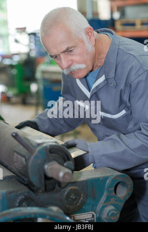 shoemaker using machine in workshop Stock Photo