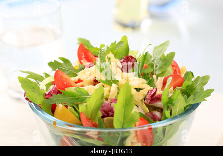 Fresh vegetable salad sprinkled with grated cheese Stock Photo