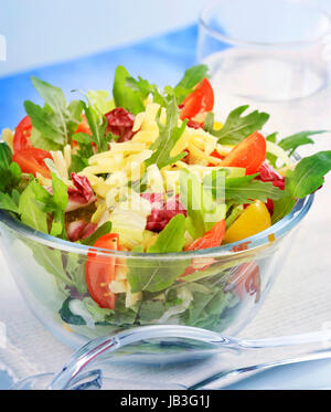 Bowl of spring salad sprinkled with grated cheese Stock Photo
