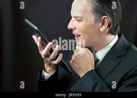 Close-up of a businessman admiring his tablet. Stock Photo