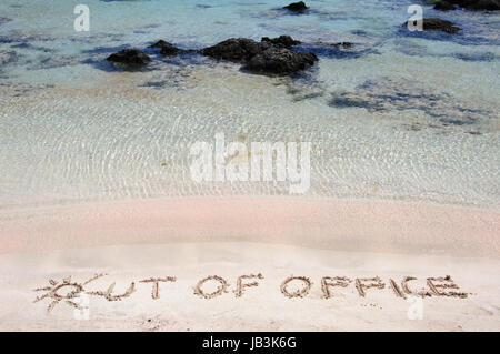 OUT OF OFFICE written on sand on a beautiful beacOUT OF OFFICE written on sand on a beautiful beach, blue waves in background, blue waves in background .Relax concept image Stock Photo