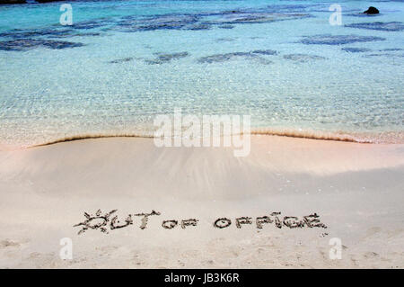 OUT OF OFFICE written on sand on a beautiful beacOUT OF OFFICE written on sand on a beautiful beach, blue waves in background, blue waves in background .Relax concept image Stock Photo