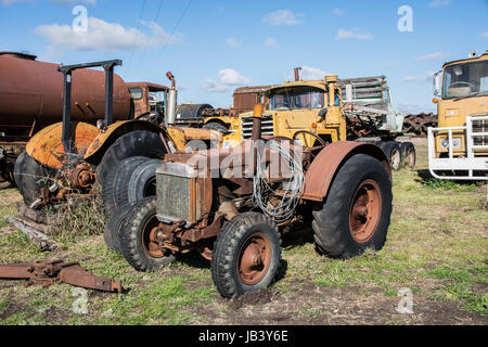 An old Case Tractor in a Vehicle Graveyard. Stock Photo