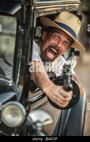 One retro 1920s gangster shooting machine gun Stock Photo