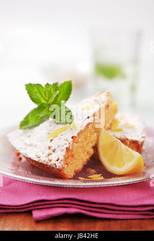 Slices of sponge cake sprinkled with powdered sugar Stock Photo