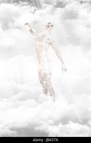 Frozen woman standing in the clouds Stock Photo