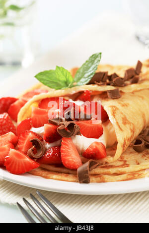 Crepes filled with sweet cream cheese and strawberries Stock Photo