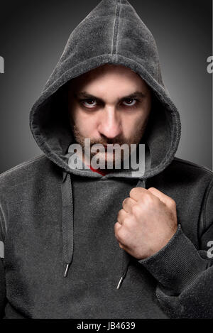 Young angry gangster with the hood on his head Stock Photo