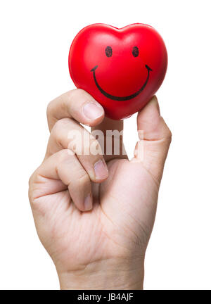 Hand squeezing stress ball in heart shape Stock Photo