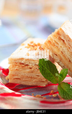 Slices of apple mille-feuille cake dusted with powdered sugar Stock Photo