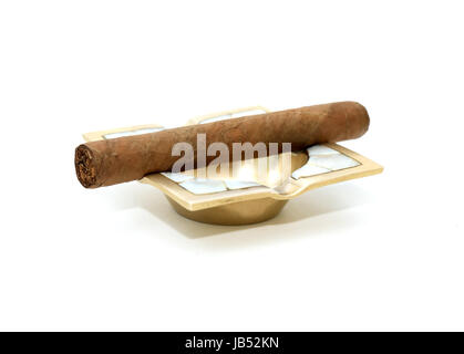 One Cuban cigar on vintage brass ashtray against white background Stock Photo