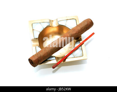 One Cuban cigar on vintage brass ashtray against white background Stock Photo